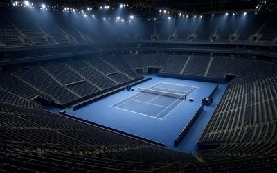 ATP Finals - arena indoor con campo in cemento blu e tribune vuote sotto i riflettori